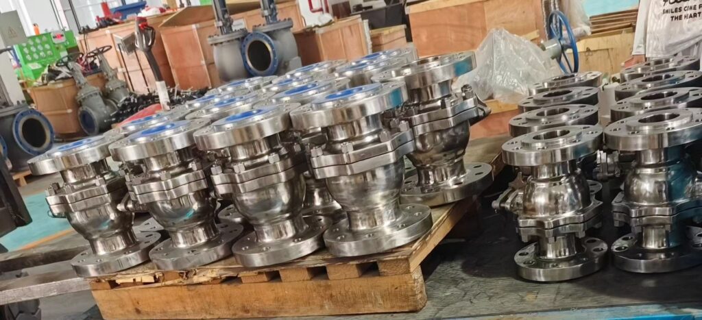 Piping engineers examining valves in a processing refinery